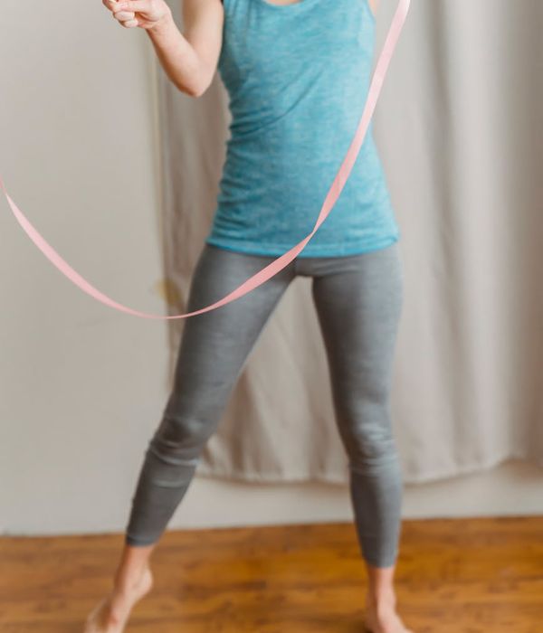 Active woman performing rhythmic exercises in a modern minimal studio